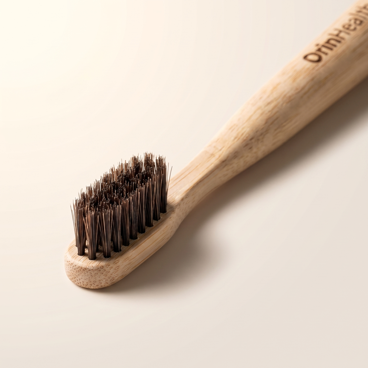 Close-up of the OrinHealth bamboo toothbrush head with natural horsehair bristles set into drilled holes